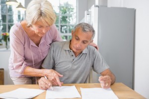 Wife showing where to sign to her husband