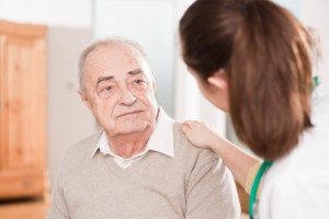 Doctor laying hand on senior man's shoulder