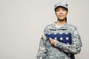 Soldier holding folded American flag