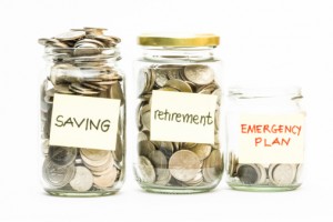 Coins in jar with saving, retirement and emergency plan labels